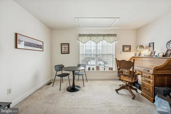 a workspace with furniture and a large window