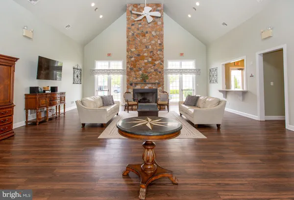 a living room with furniture a table and a large window