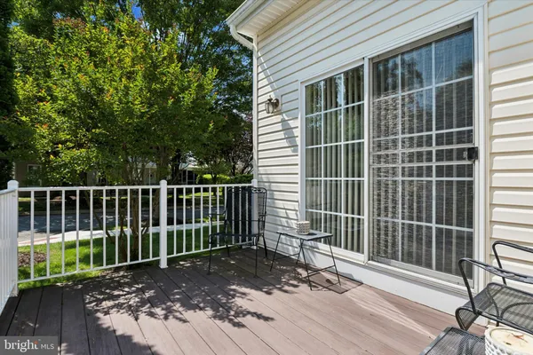 a view of a deck with a floor to ceiling window