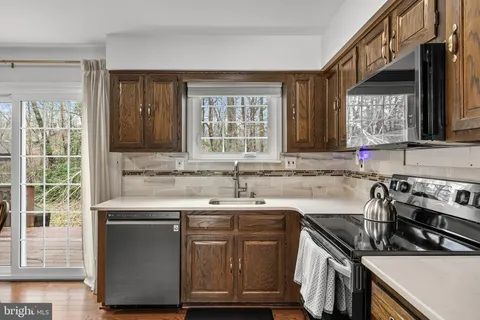 a kitchen with a sink stove and cabinets