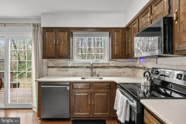 a kitchen with a sink stove and cabinets