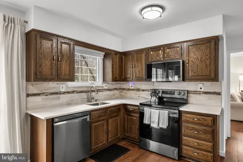 a kitchen with stainless steel appliances granite countertop a stove and a sink