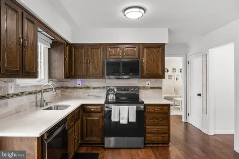 a kitchen with a table chairs refrigerator and microwave