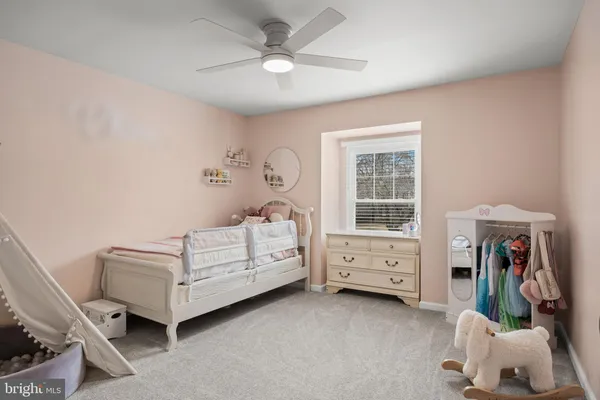 a bedroom with furniture and a window
