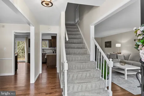 a view of closet with window and wooden floor