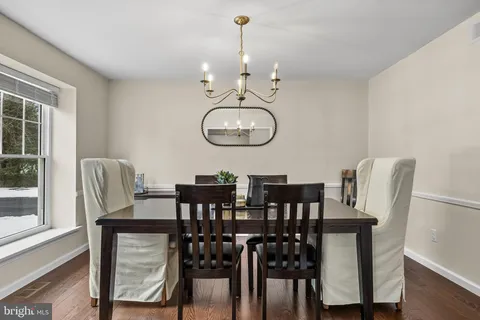 a view of a dining room with furniture and a window