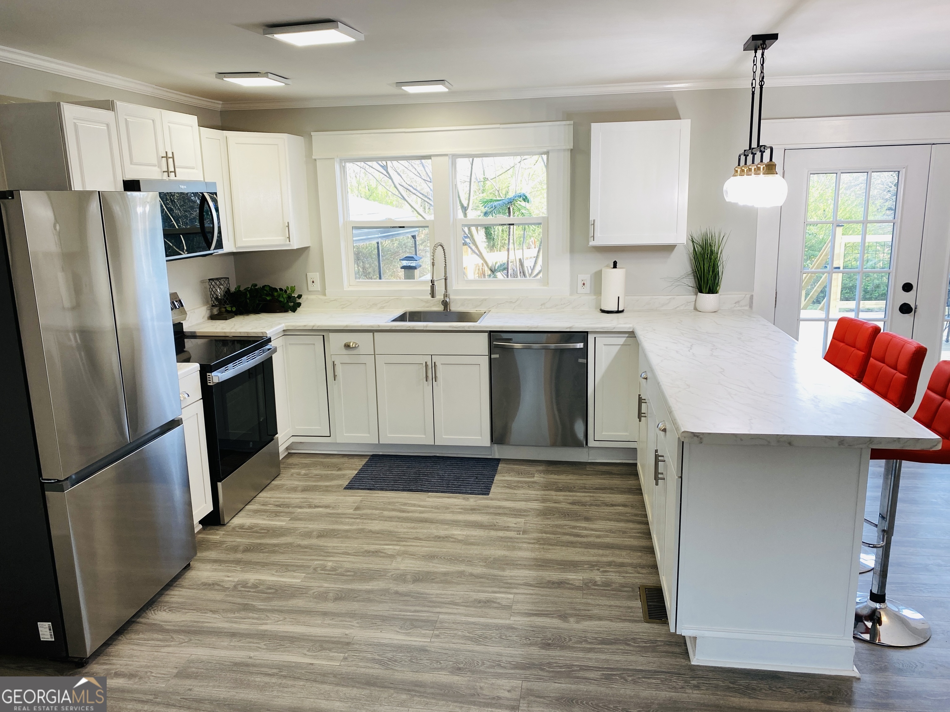 288 Davis Avenue Toccoa, GA 30577 - Photo 13 of 36 a kitchen with stainless steel appliances granite countertop a refrigerator a sink dishwasher a stove with wooden floors