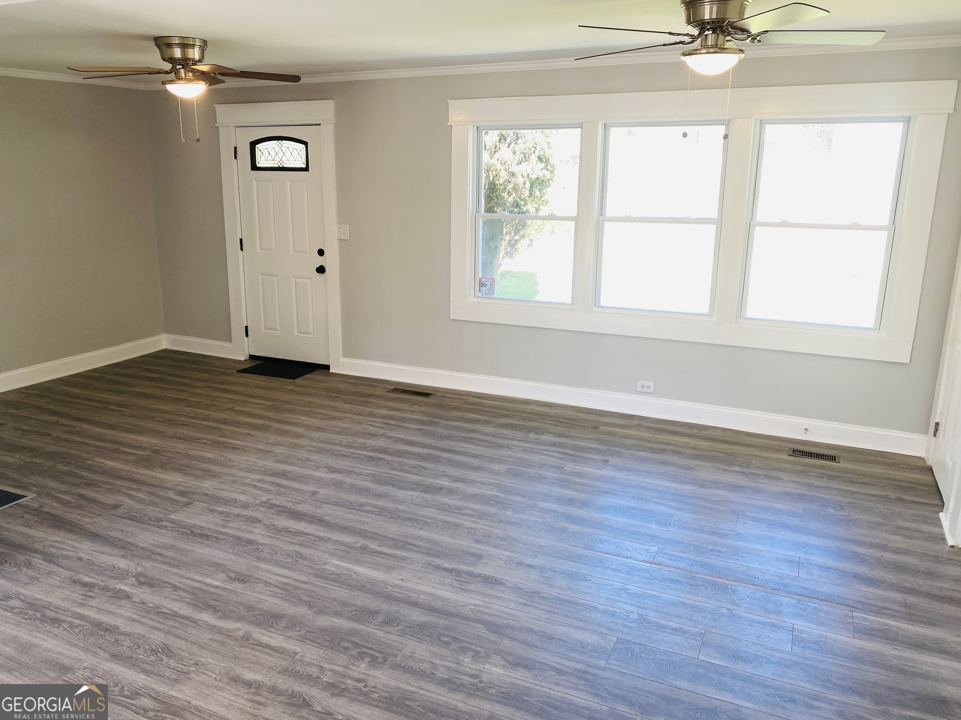 288 Davis Avenue Toccoa, GA 30577 - Photo 17 of 36 an empty room with wooden floor and windows