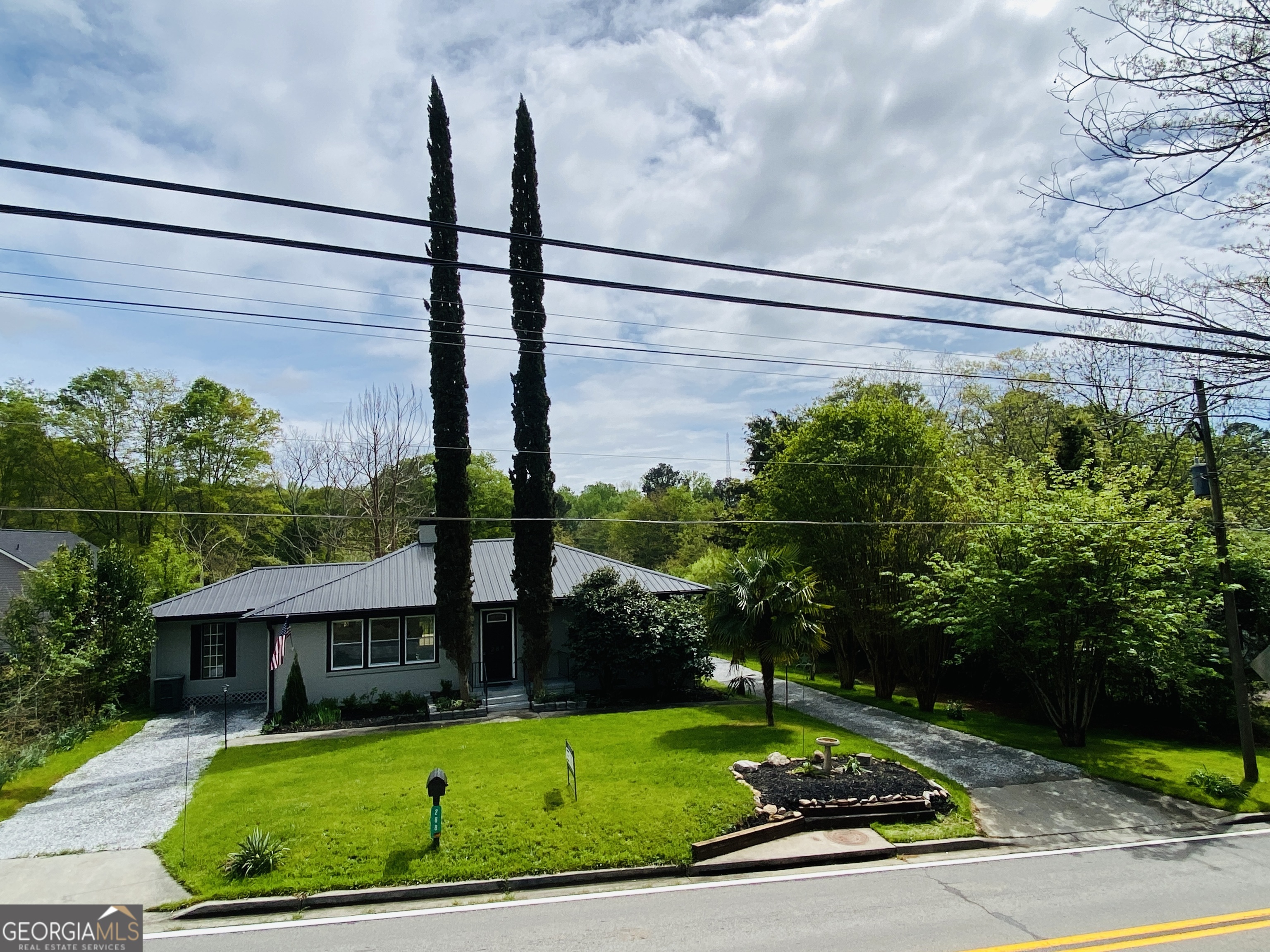 288 Davis Avenue Toccoa, GA 30577 - Photo 2 of 36 a view of a back yard of a house with a street sign