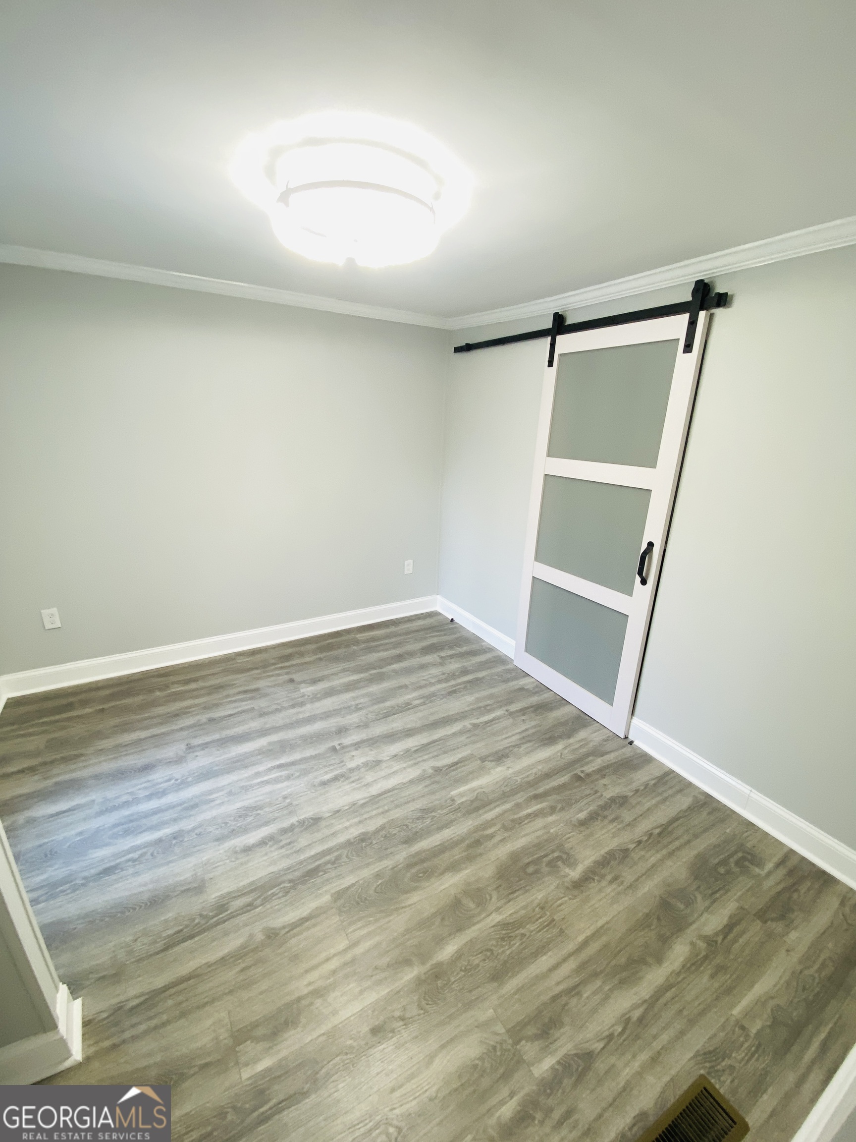 288 Davis Avenue Toccoa, GA 30577 - Photo 21 of 36 an empty room with wooden floor and fan