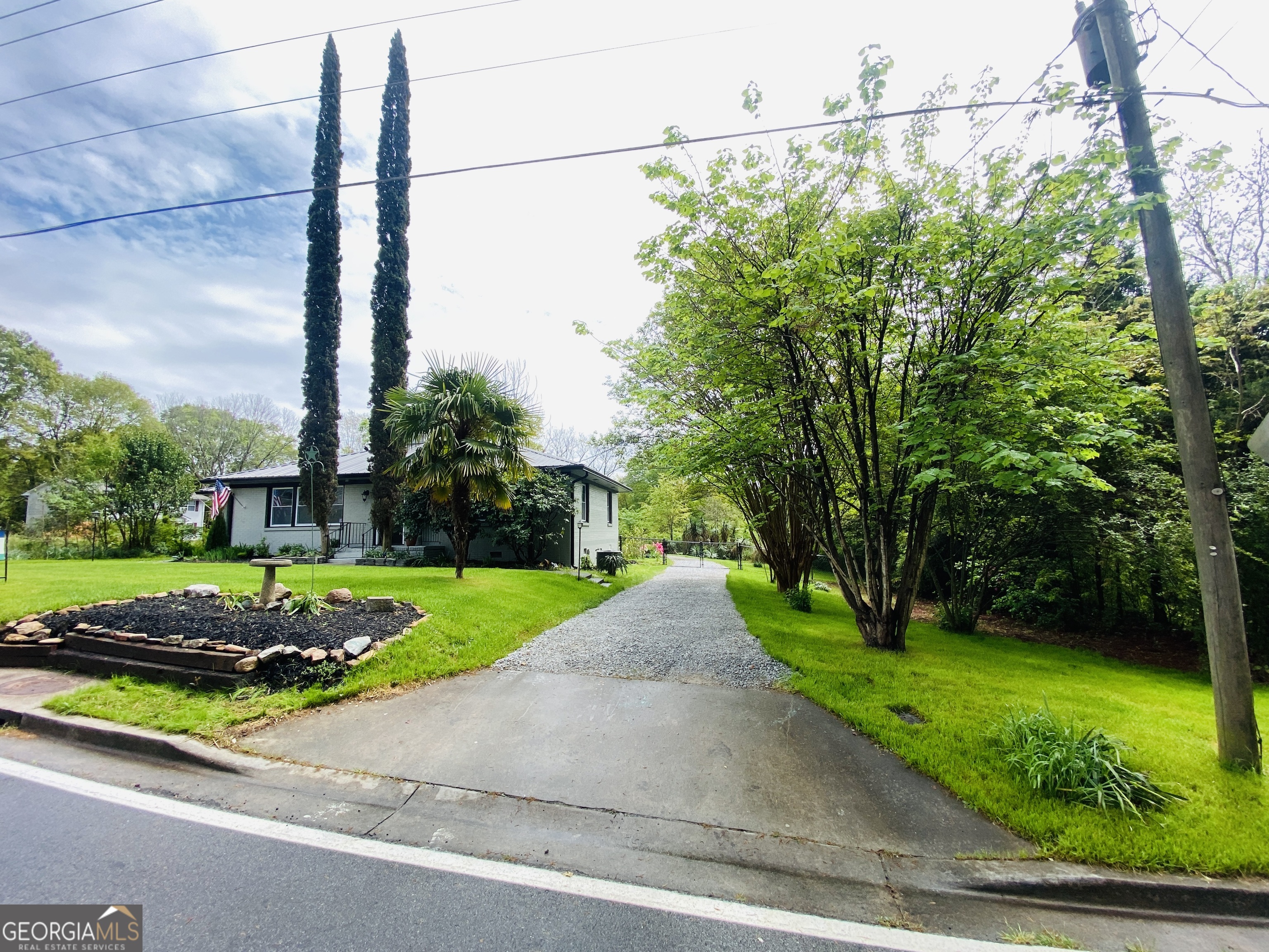 288 Davis Avenue Toccoa, GA 30577 - Photo 10 of 36 a view of a street with a small yard and large trees
