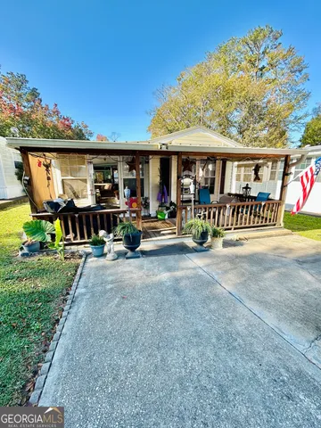 a view of a chairs and table in front of house