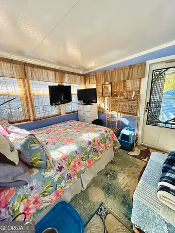 a bedroom with a bed window and couch