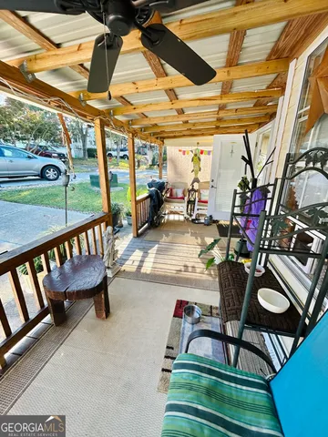 a view of a chairs and table in patio with a yard