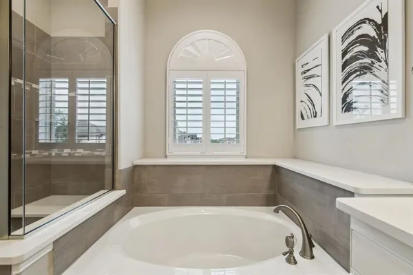 a bathroom with a bathtub and window