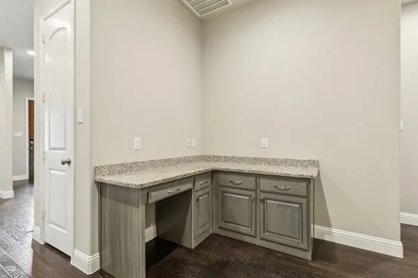 a utility room with granite countertop a sink and dishwasher