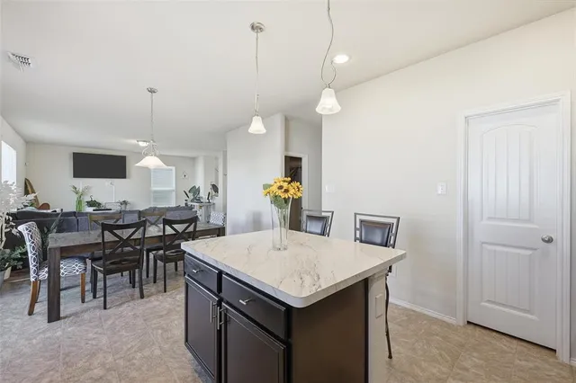 a kitchen with a table and chairs