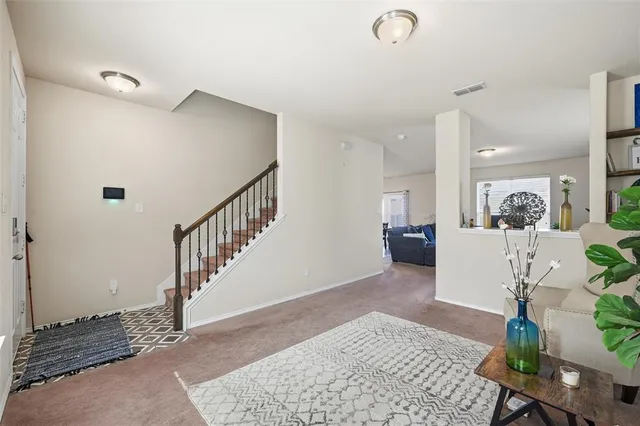 a living room with furniture and a rug