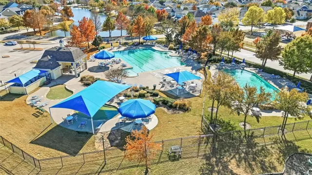 a view of a swimming pool with outdoor seating