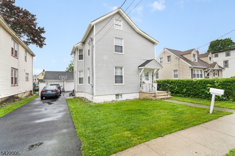 60 Searing Street Dover, NJ 07801 - Photo 1 of 23 a front view of a house with a garden and yard