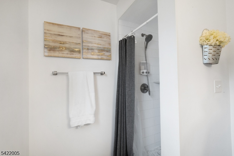 60 Searing Street Dover, NJ 07801 - Photo 11 of 23 a bathroom with a shower and a mirror