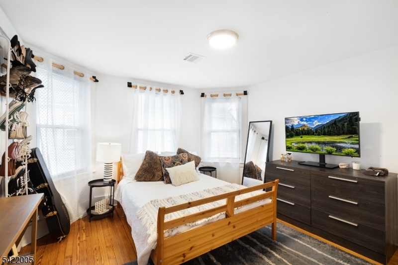 60 Searing Street Dover, NJ 07801 - Photo 16 of 23 a bedroom with a bed and flat screen tv