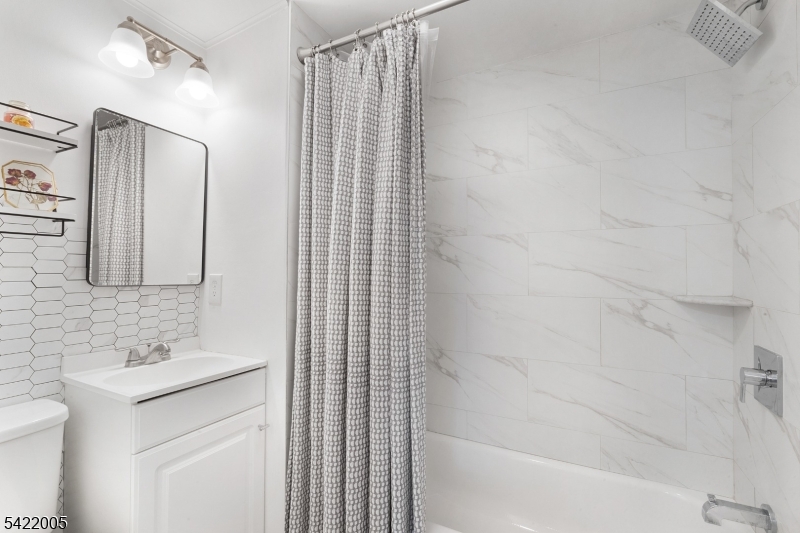 60 Searing Street Dover, NJ 07801 - Photo 18 of 23 a bathroom with a sink and a mirror