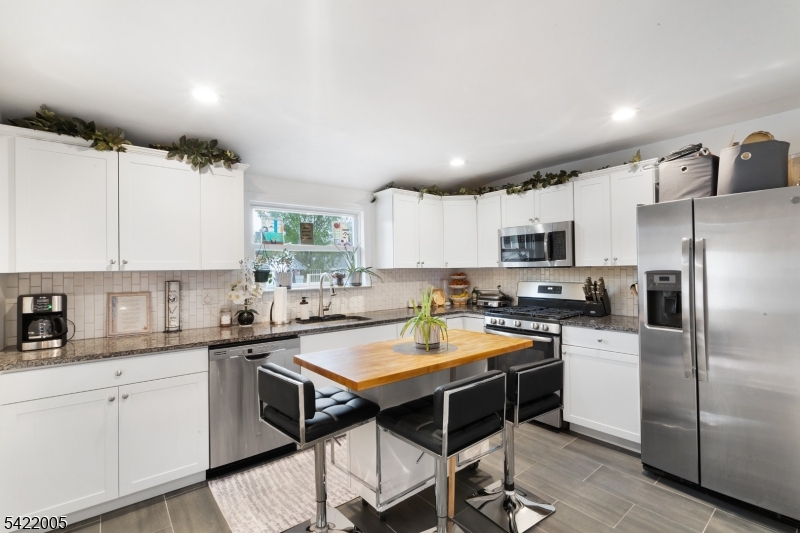 60 Searing Street Dover, NJ 07801 - Photo 2 of 23 a kitchen with a sink a counter space appliances and cabinets