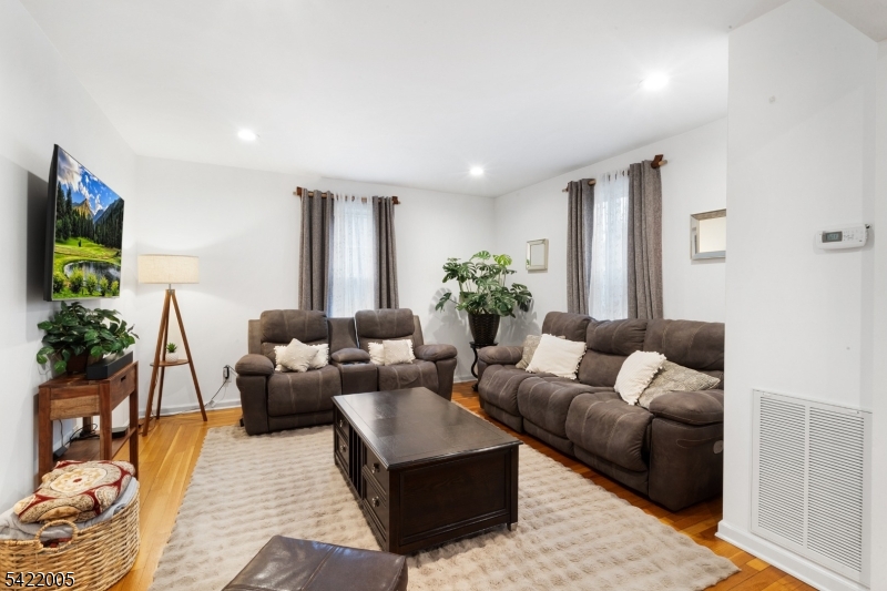 60 Searing Street Dover, NJ 07801 - Photo 9 of 23 a living room with furniture and a flat screen tv
