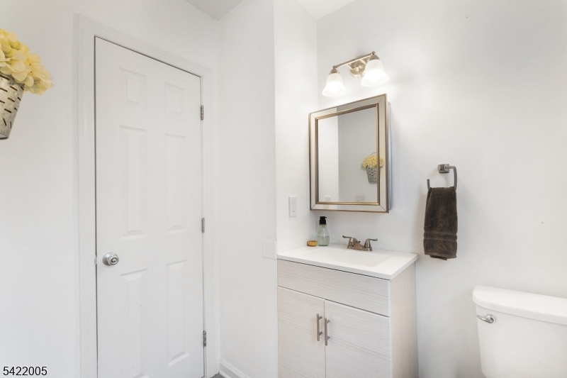 60 Searing Street Dover, NJ 07801 - Photo 10 of 23 a bathroom with a sink vanity and a mirror