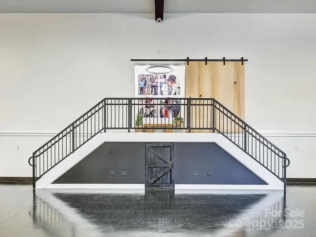 a view of a room with wooden floor and windows