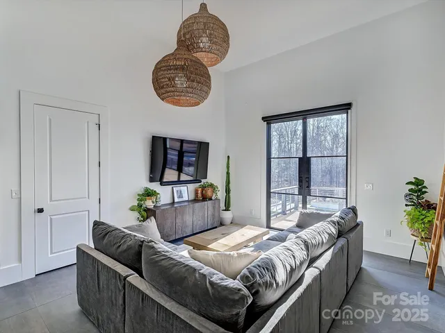 a kitchen with stainless steel appliances kitchen island granite countertop a refrigerator a stove and a wooden floors