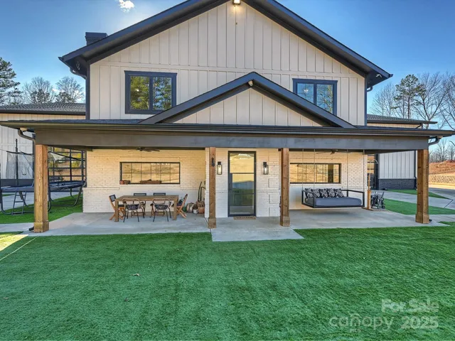 a view of a house with a yard and sitting area