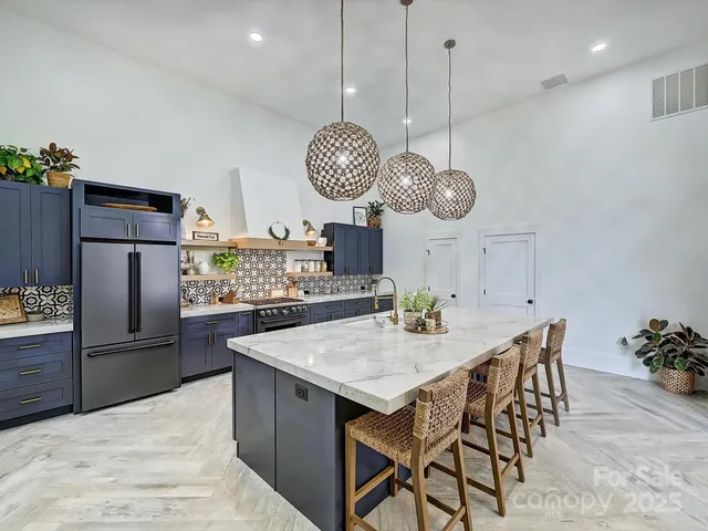 a room with a chandelier a sink and a clock