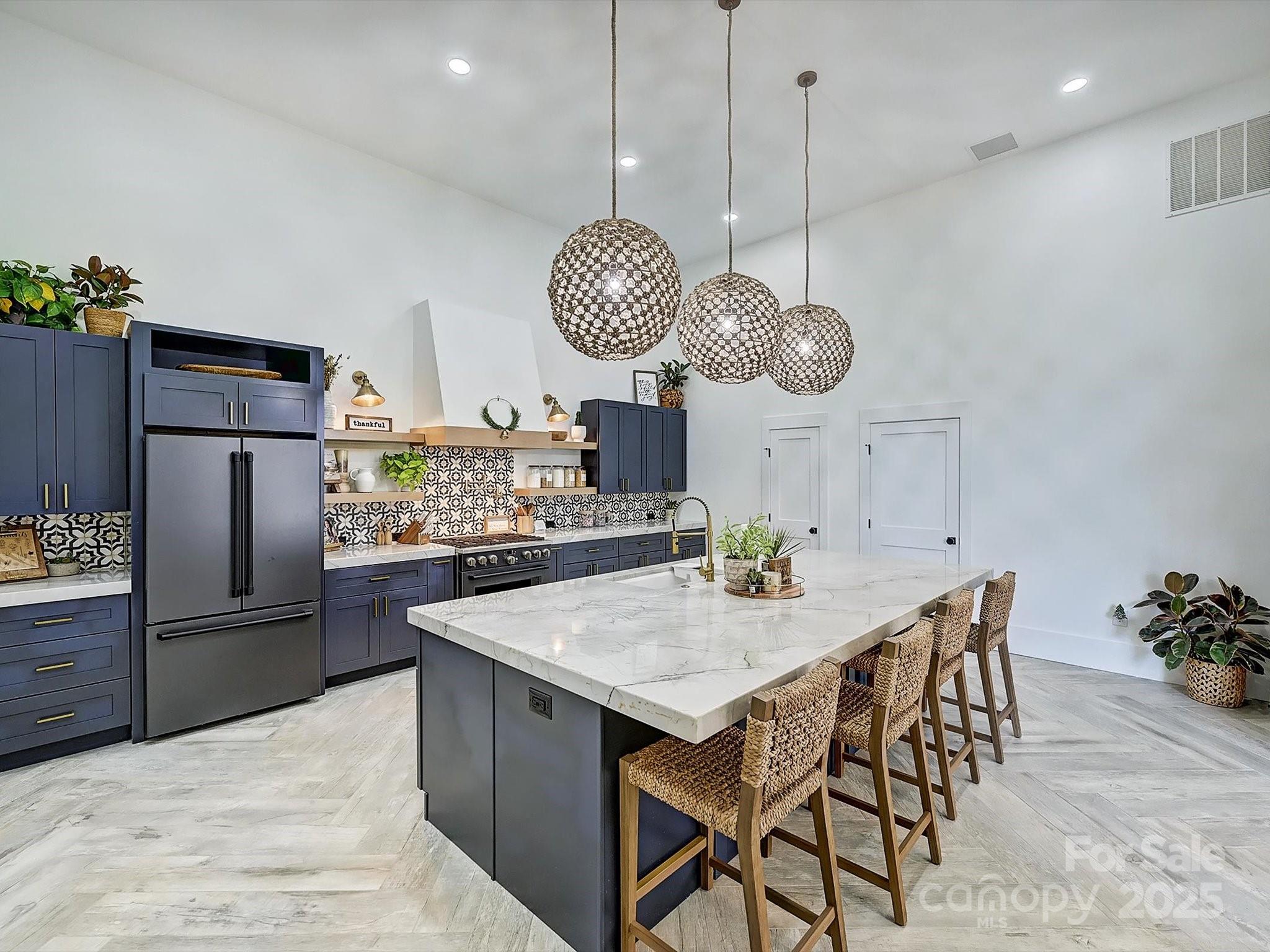 1525 Shinnville Road Cleveland, NC 27013 - Photo 21 of 48 a kitchen with stainless steel appliances kitchen island granite countertop a refrigerator a stove and a wooden floors