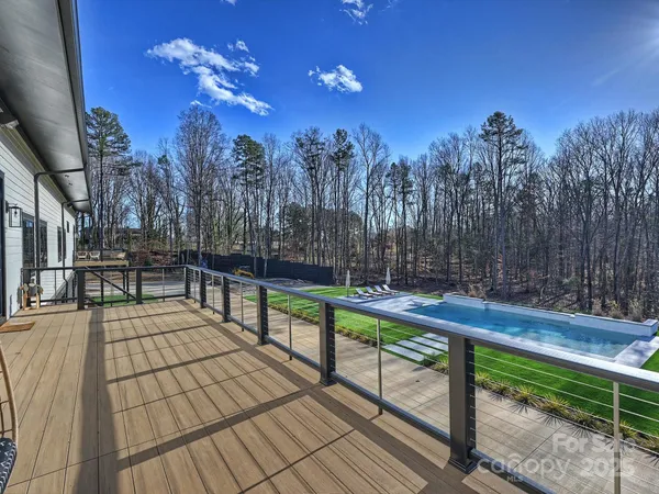 a view of outdoor space with swimming pool and green space