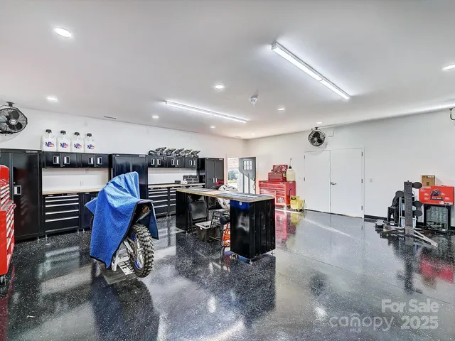 a kitchen with a table and a a refrigerator