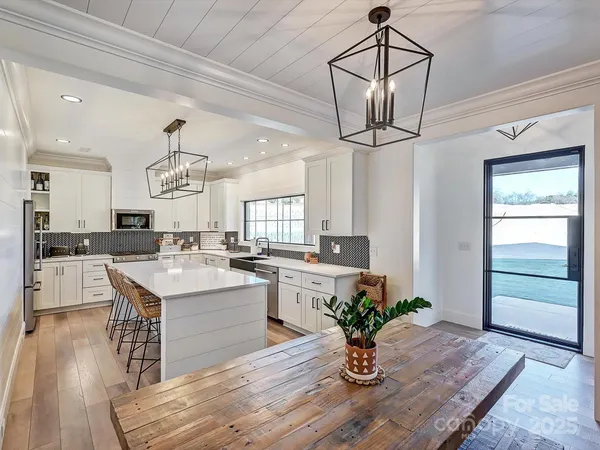 a kitchen with a table and chandelier