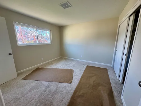 a view of a room with wooden floor and windows
