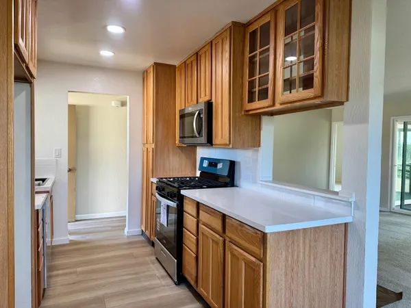 a kitchen that has a sink and a stove in it