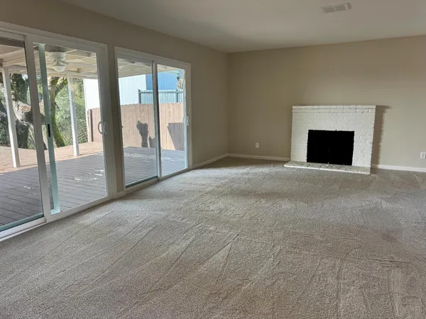 a view of an empty room with glass door