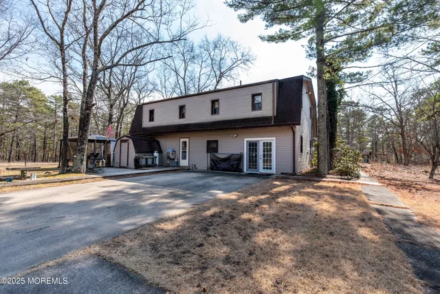 a front view of a house with a yard covered in snow