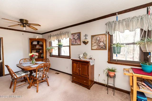 a kitchen with a table chairs refrigerator and cabinets