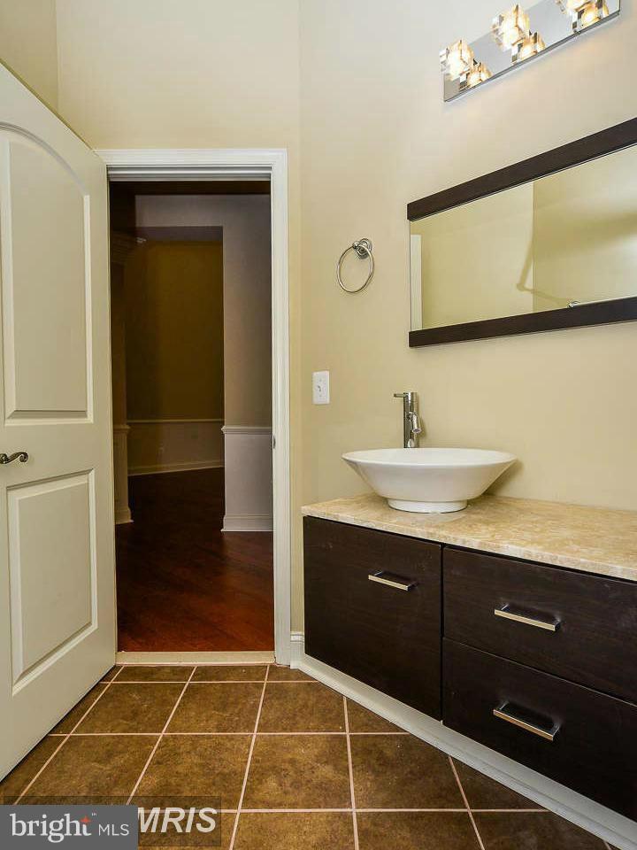8536 Old Keene Mill Road Springfield, VA 22152 - Photo 22 of 30 a bathroom with a sink and a mirror
