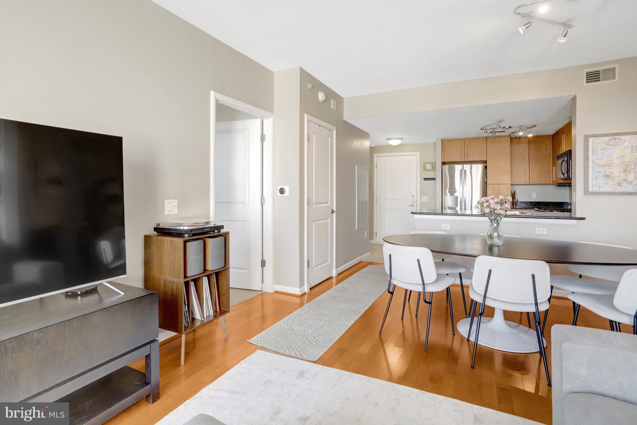 1021 North Garfield Street, Unit 914 Arlington, VA 22201 - Photo 11 of 63 a view of a dining room with furniture and a flat screen tv