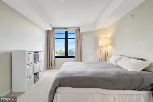 a bedroom with a bed and a lamp