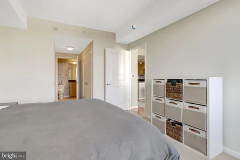 a bathroom with a granite countertop sink a toilet and a mirror