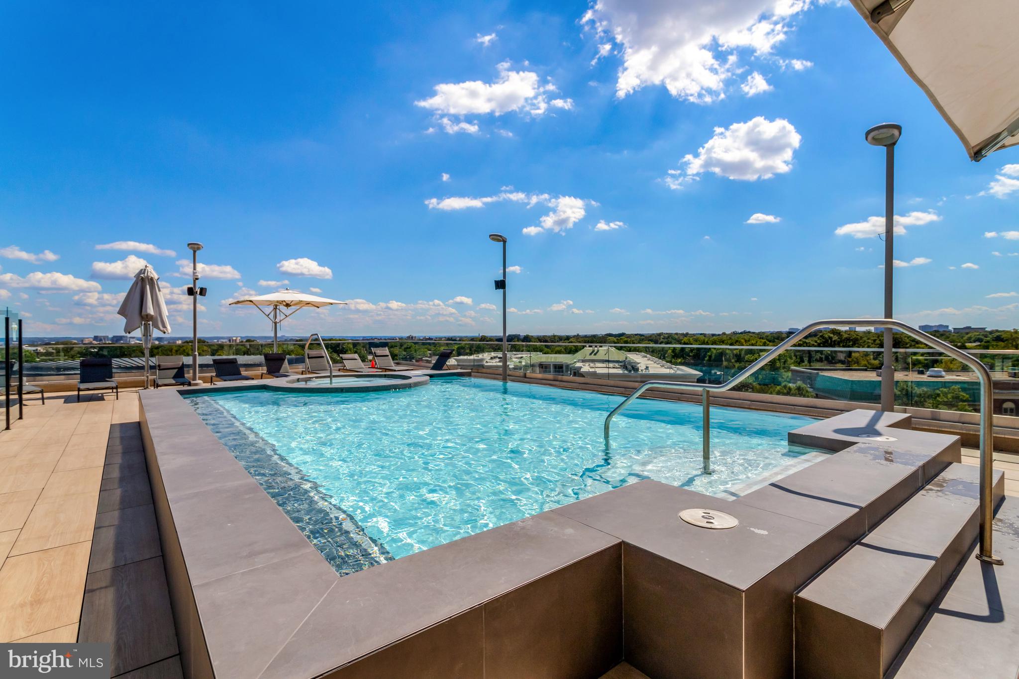 1021 North Garfield Street, Unit 914 Arlington, VA 22201 - Photo 26 of 63 a view of a swimming pool with chairs