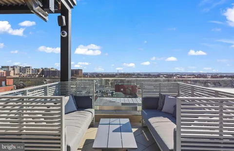 a living room with fireplace furniture and a potted plant