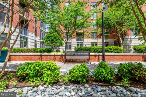 a front view of a building with a garden